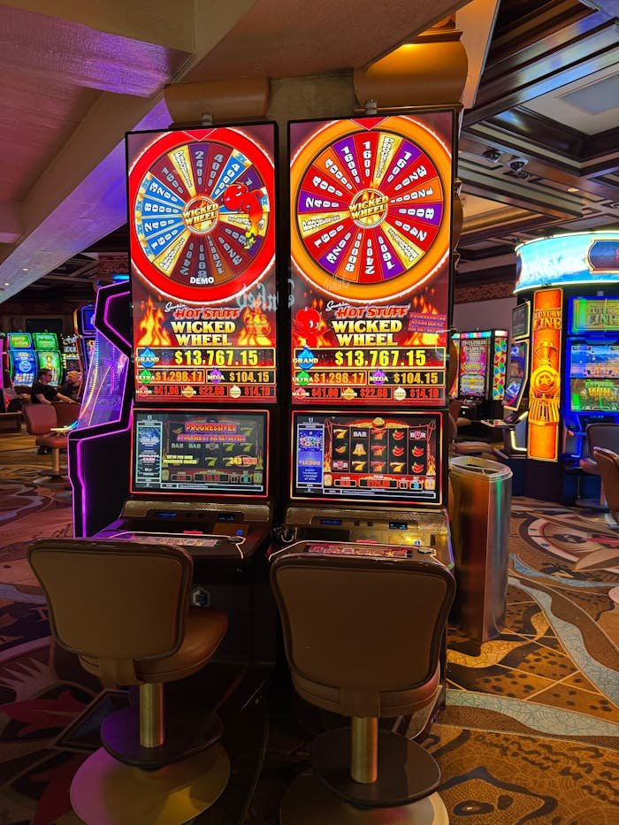 Brightly lit slot machines inside a Las Vegas casino, capturing the lively atmosphere.